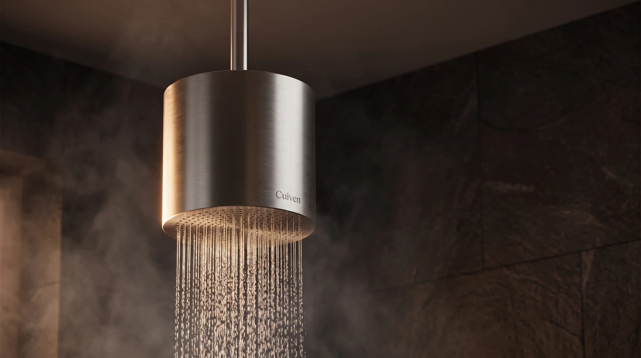 Monolith cylinder suspended from a ceiling stem with rainfall flowing from its base